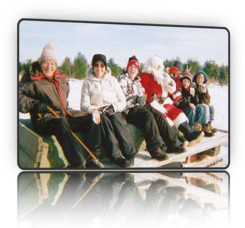 Photo of Santa, snuggled in with a family for a sleigh ride - from Fallowfield Tree Farm