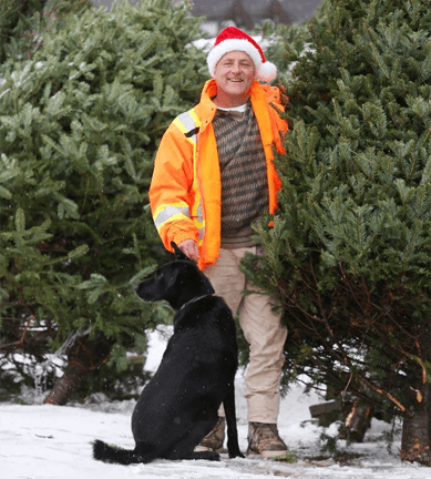 Fallowfield Tree Farms owner, Kenyy Stuyt and his best friend, choosing a Christmas tree