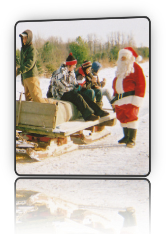 Photo of Santa sending an excited family off to choose their Christmas Tree at Fallowfield Christmas Tree Farm